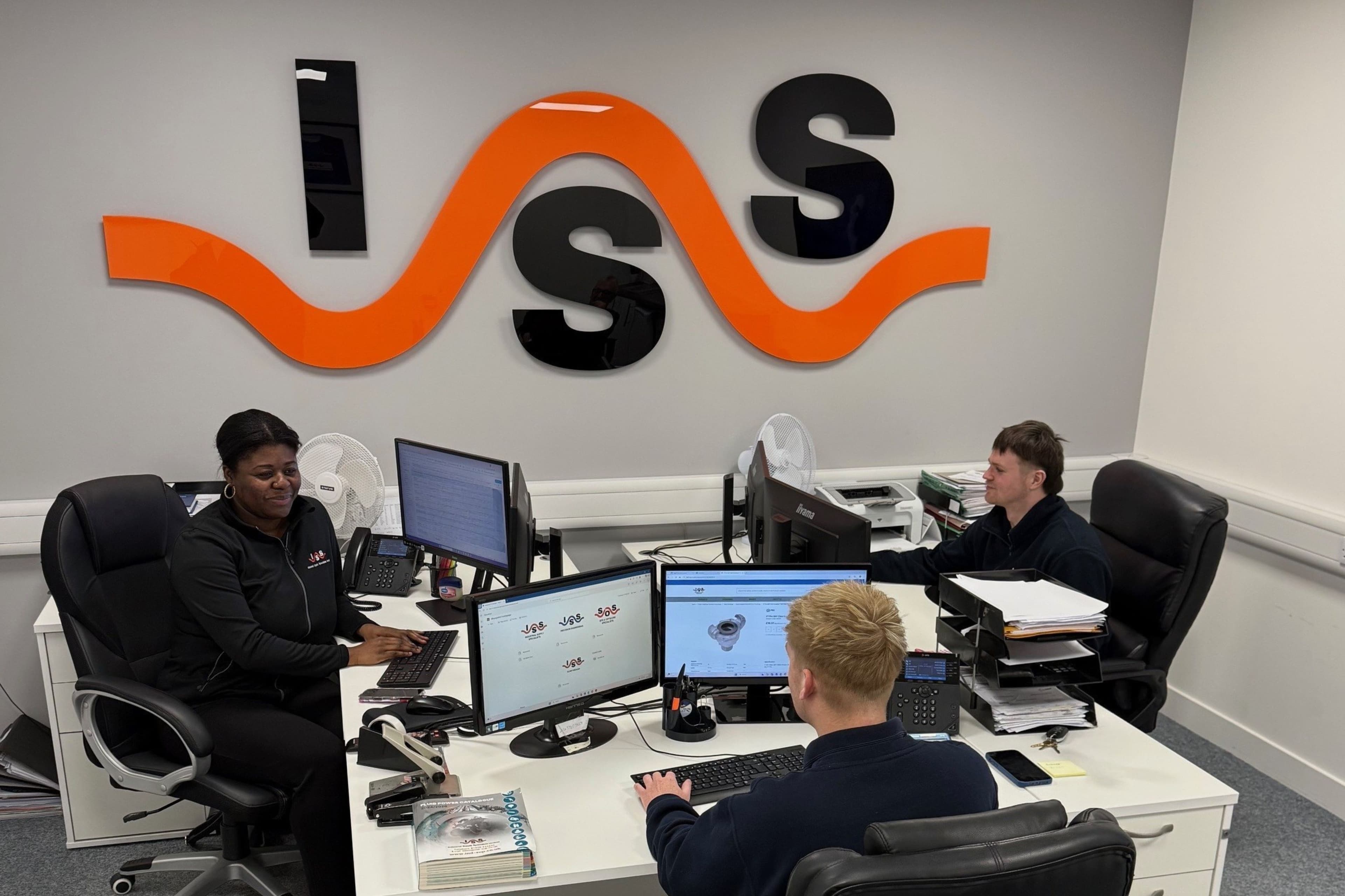 image of colleagues working at together with ISS sign in background