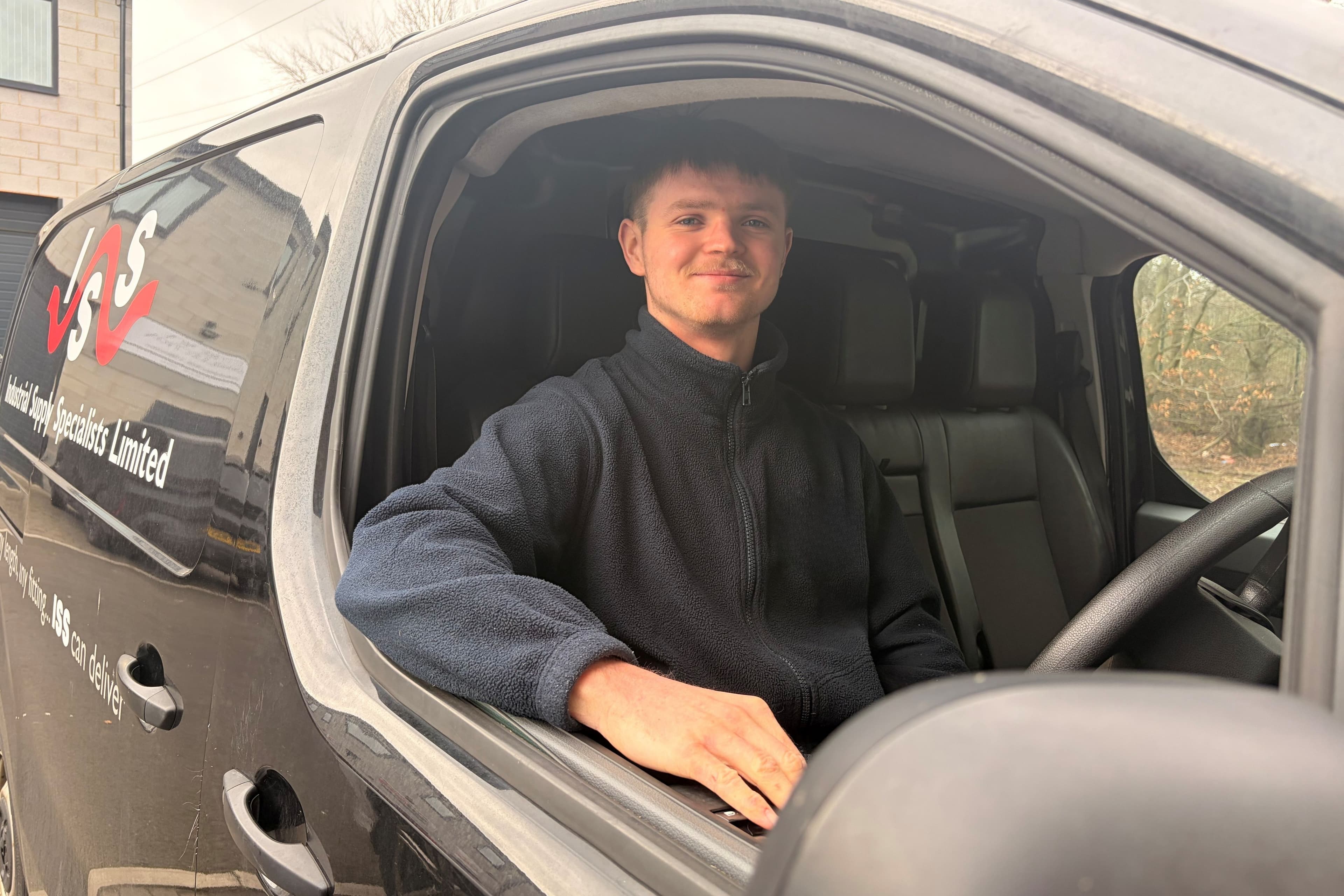 image of employee in black delivery van with iss logo